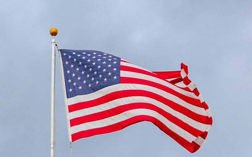 Usa Flag Waving On White Metal Pole